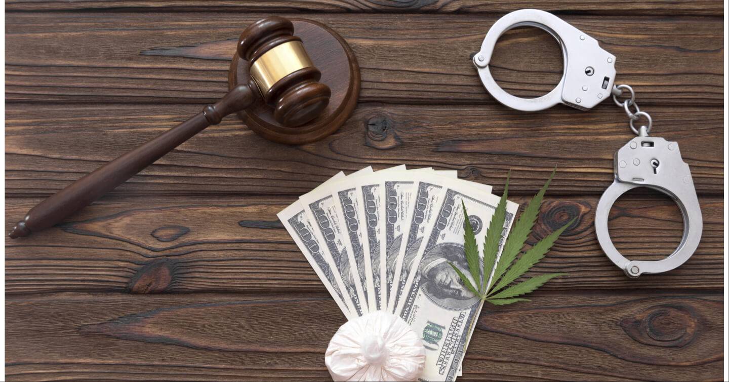 gavel, money, pot leaf, cocaine in a bag and handcuffs - Criminal Drug Lawyer